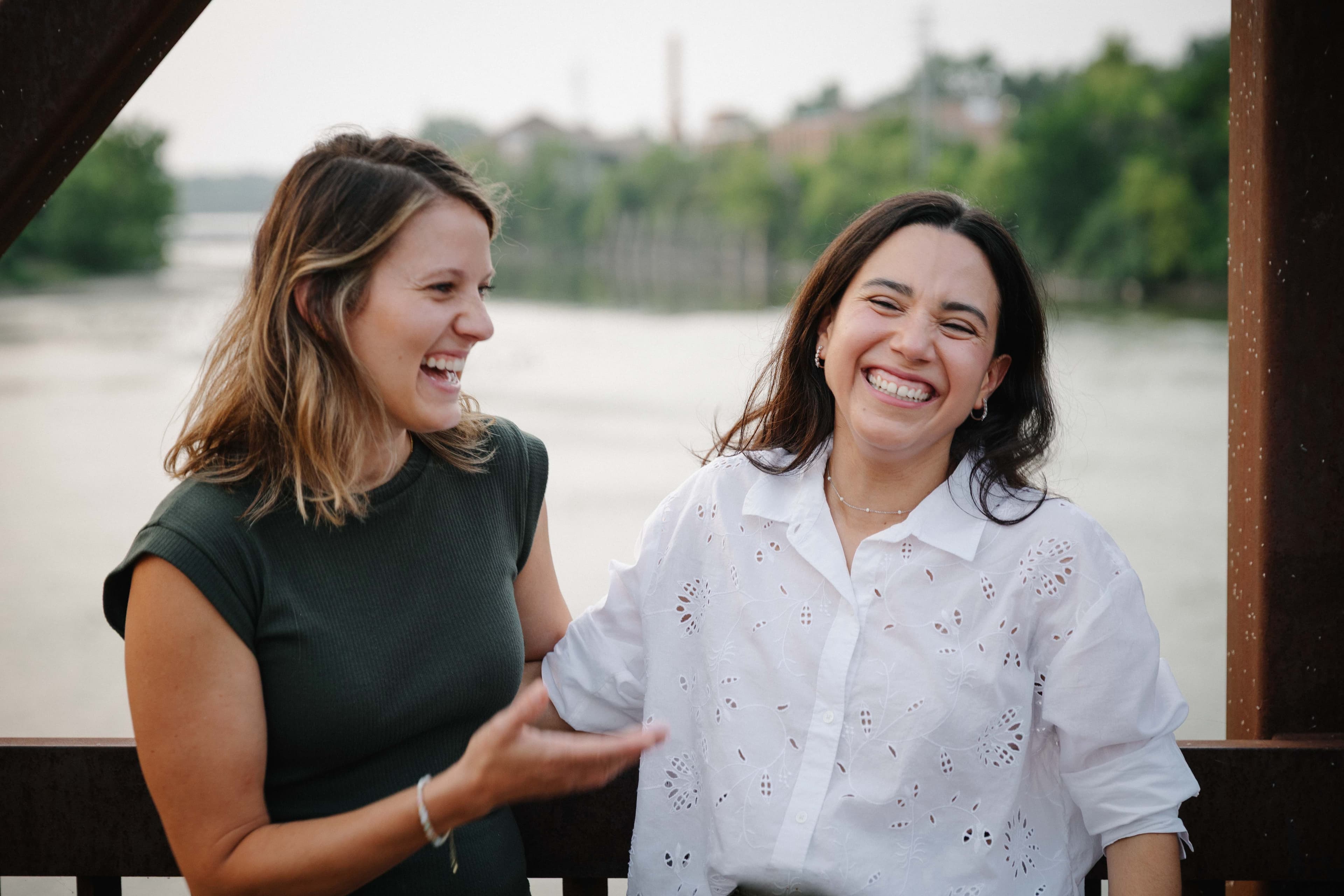 Sarah and Maria laughing together on the Batavia Riverwalk bridge